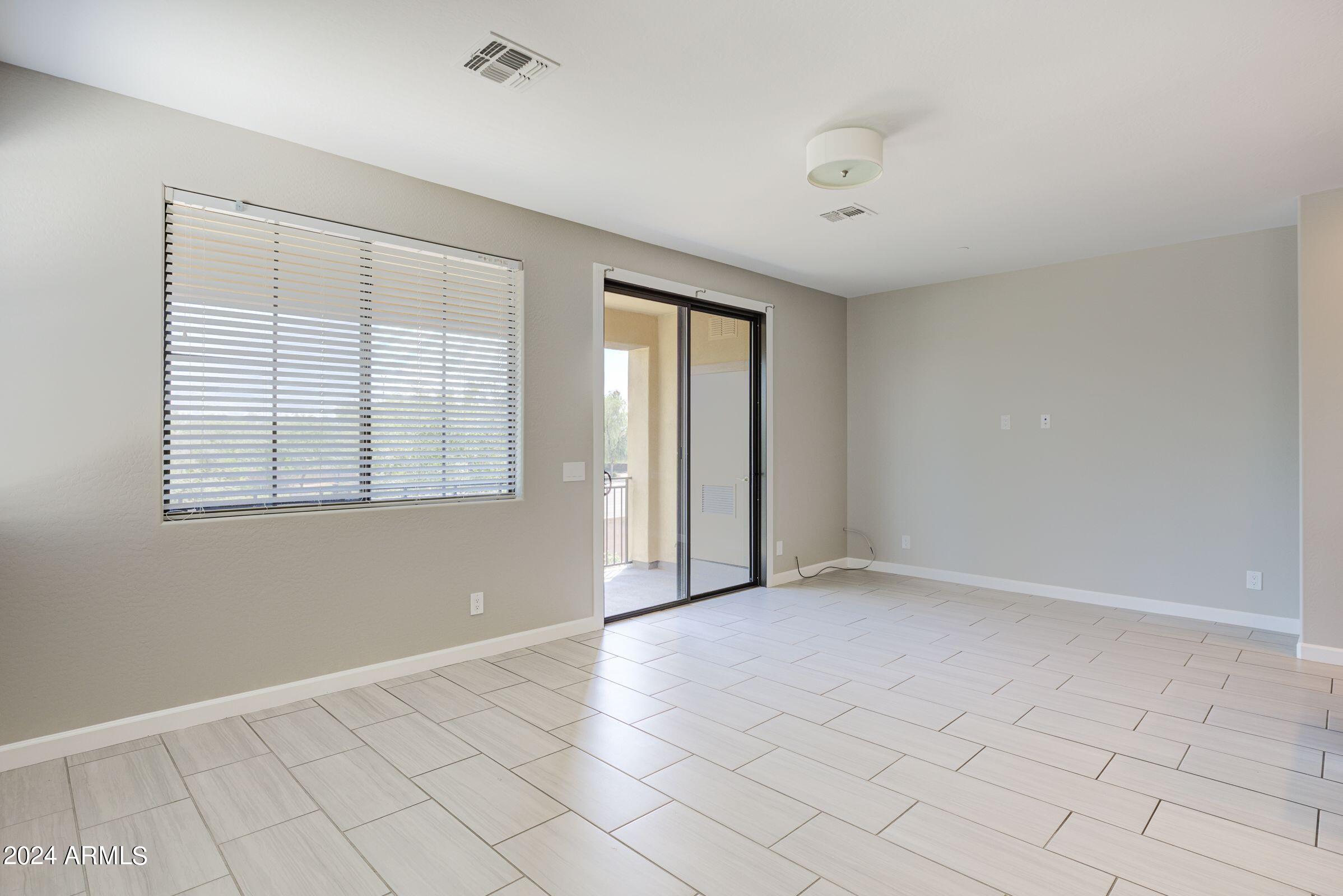 4777 South Fulton Ranch Boulevard, Unit 2066 Chandler, AZ 85248 - Photo 18 of 46 wooden floor in an empty room with a window
