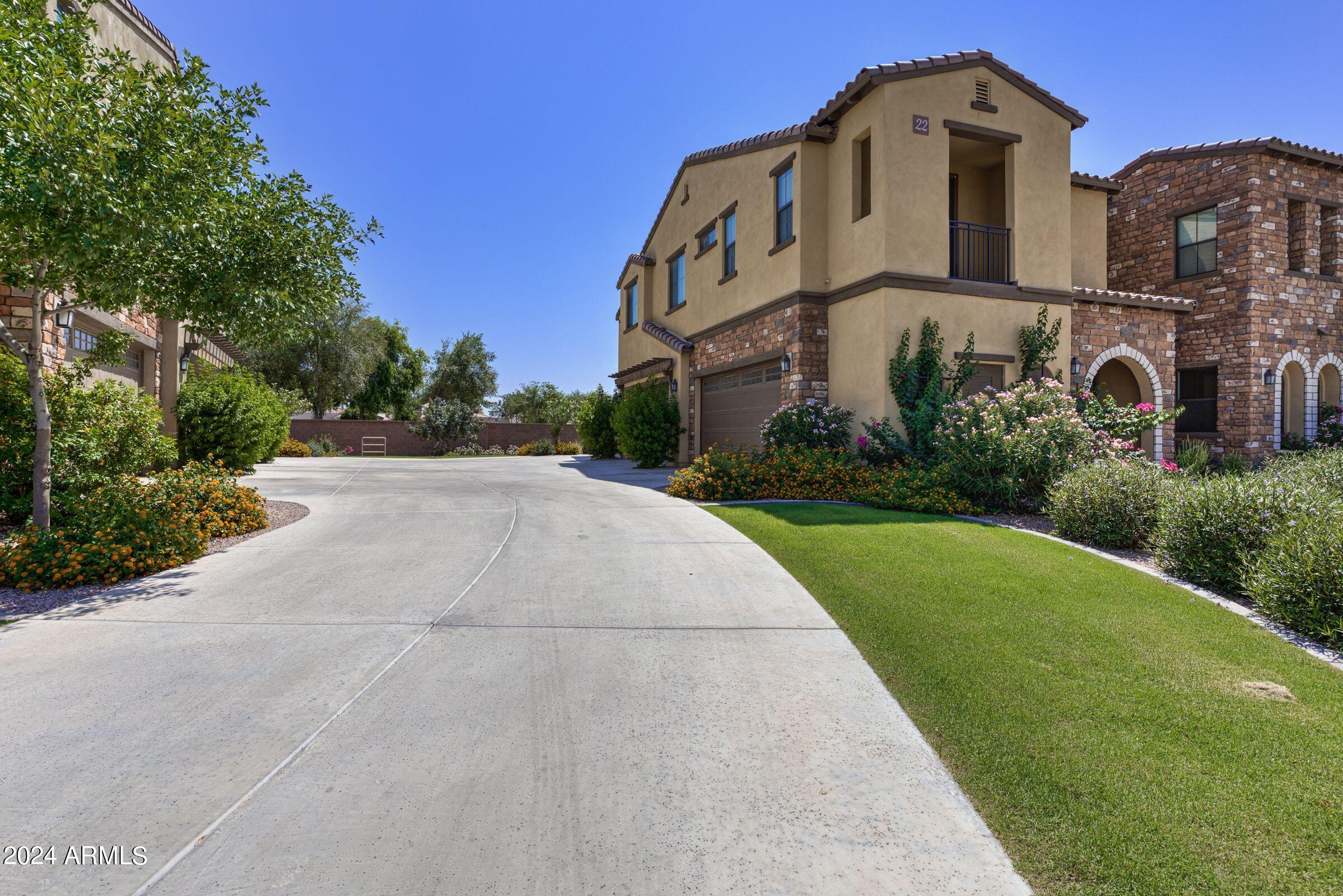 4777 South Fulton Ranch Boulevard, Unit 2066 Chandler, AZ 85248 - Photo 2 of 46 a front view of a residential apartment building with a yard