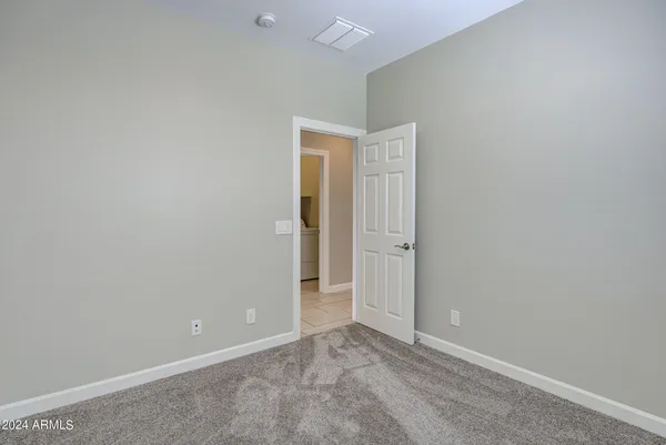 a bathroom with a sink a toilet a mirror and shower