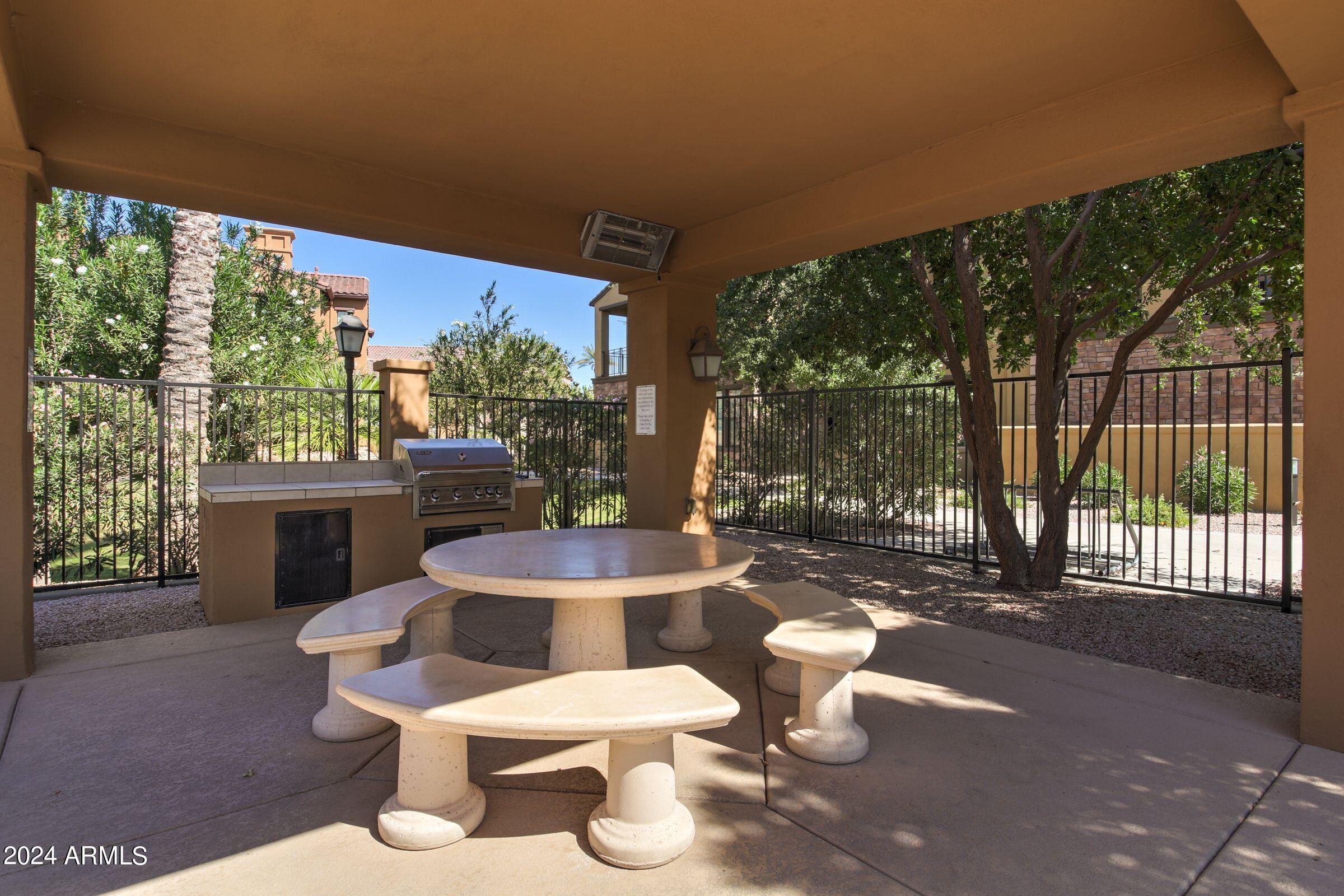 4777 South Fulton Ranch Boulevard, Unit 2066 Chandler, AZ 85248 - Photo 33 of 46 a view of a patio with table and chairs potted plants and floor to ceiling window