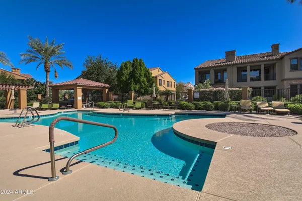 a swimming pool with outdoor seating and yard