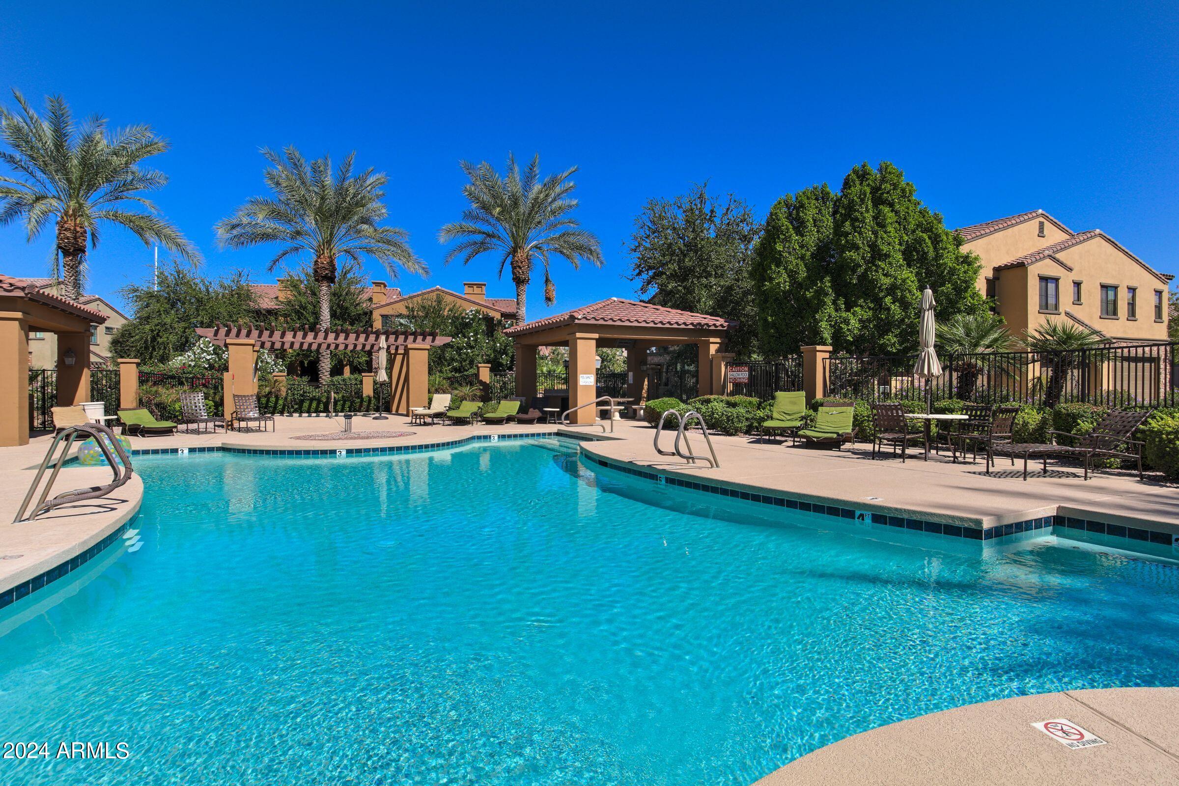 4777 South Fulton Ranch Boulevard, Unit 2066 Chandler, AZ 85248 - Photo 36 of 46 a swimming pool with outdoor seating and yard