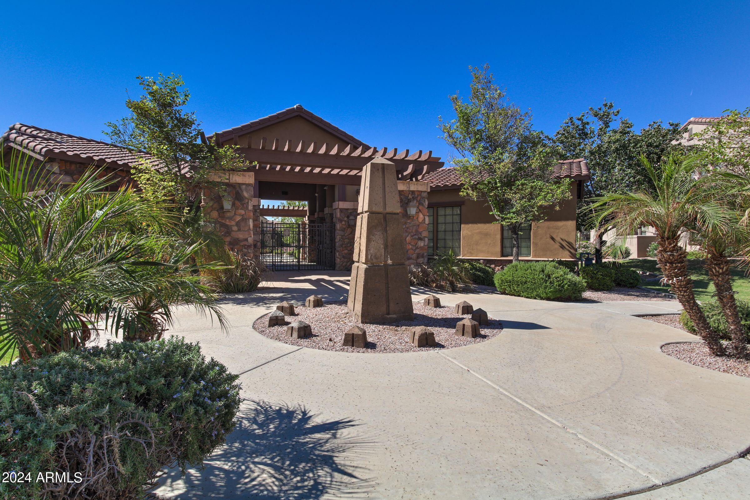 4777 South Fulton Ranch Boulevard, Unit 2066 Chandler, AZ 85248 - Photo 38 of 46 a view of a building with potted plants and a bench