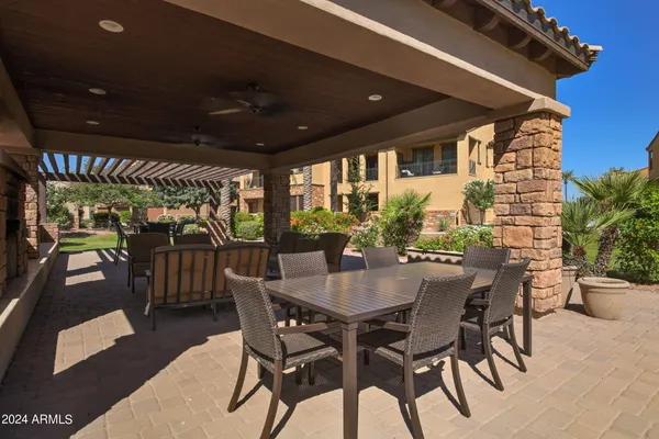 a view of a patio with table and chairs with wooden floor and fence