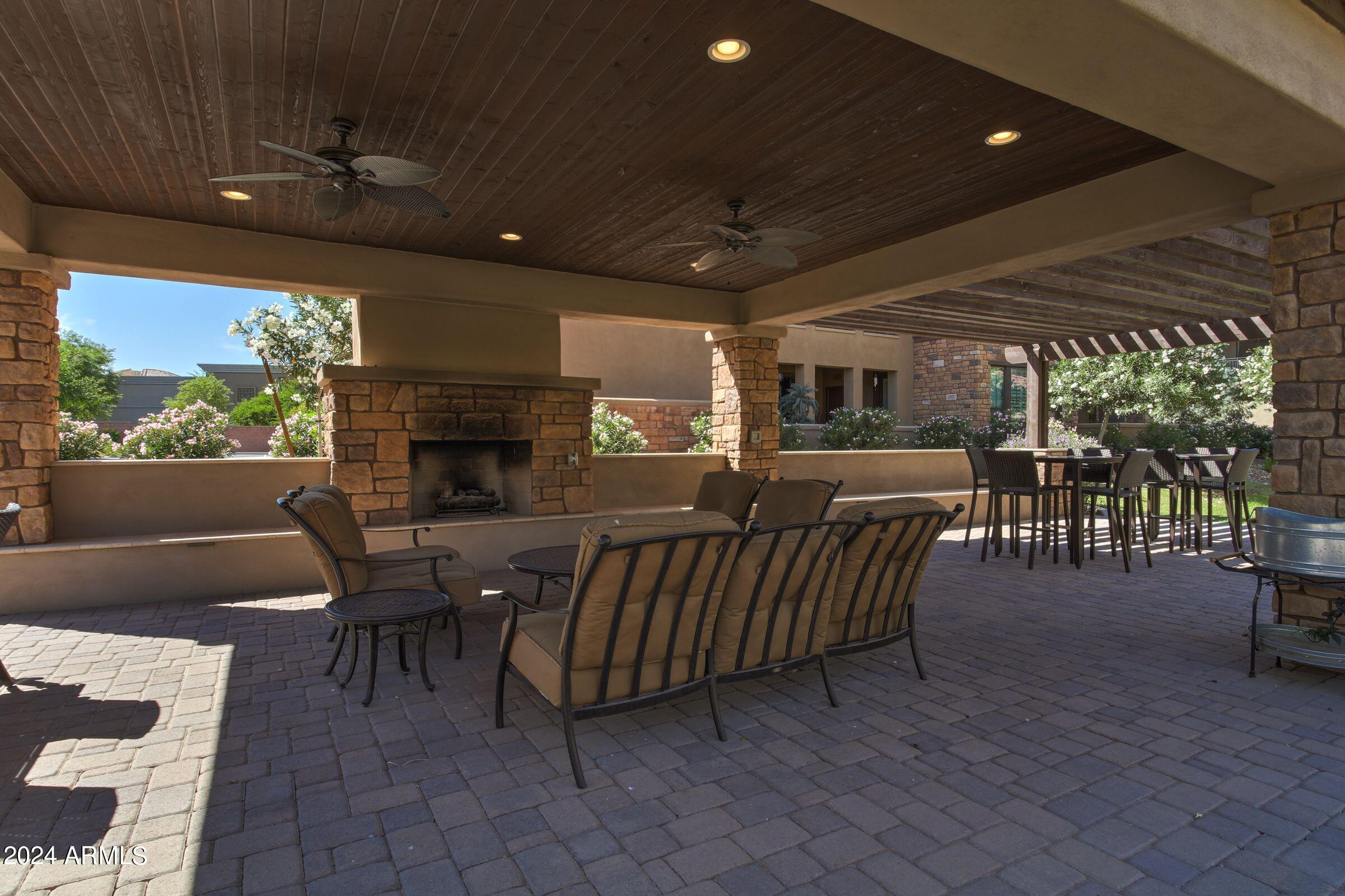 4777 South Fulton Ranch Boulevard, Unit 2066 Chandler, AZ 85248 - Photo 43 of 46 a view of a patio with table and chairs with wooden floor and fence