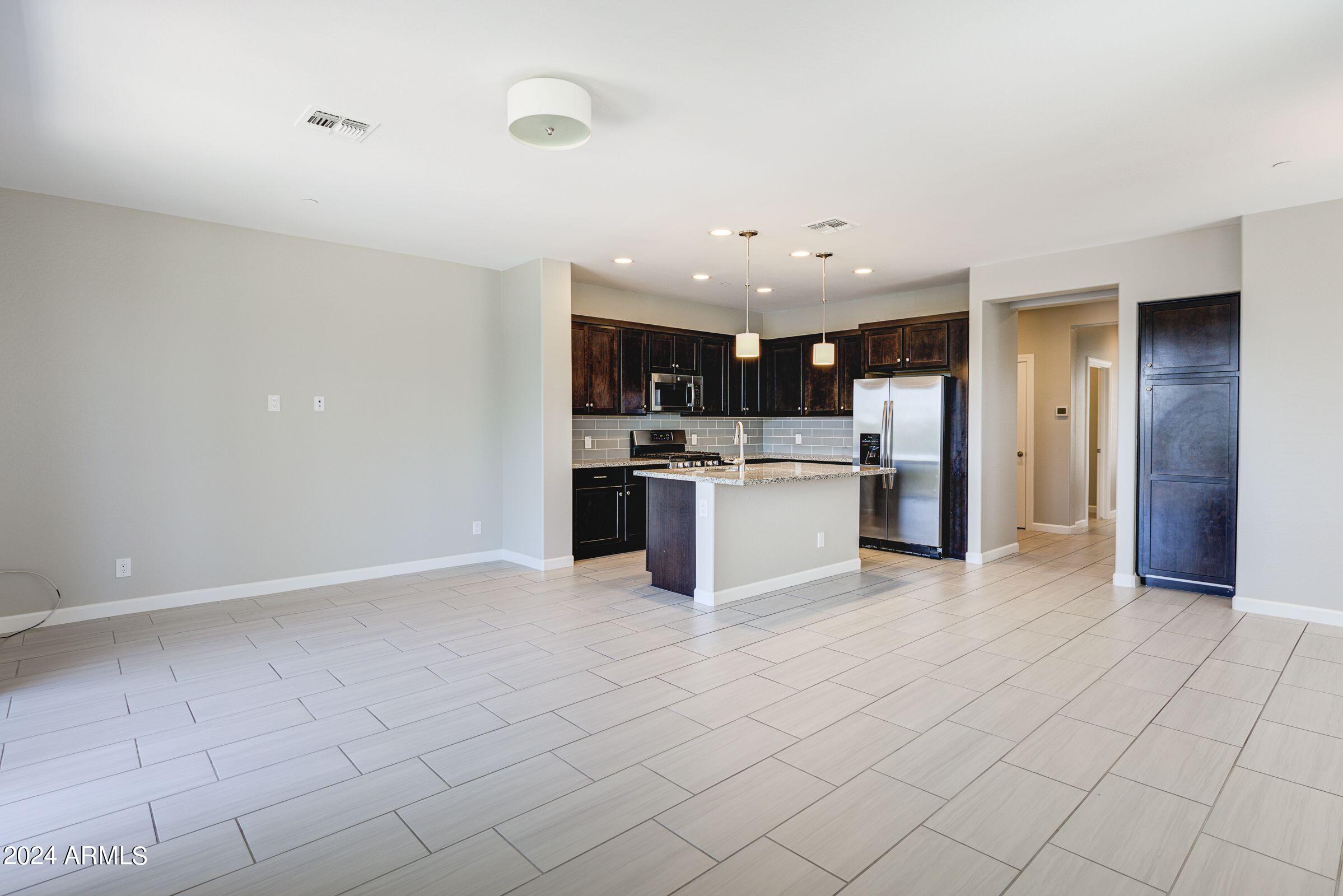 4777 South Fulton Ranch Boulevard, Unit 2066 Chandler, AZ 85248 - Photo 10 of 46 a view of kitchen with kitchen island stainless steel appliances a sink and cabinets