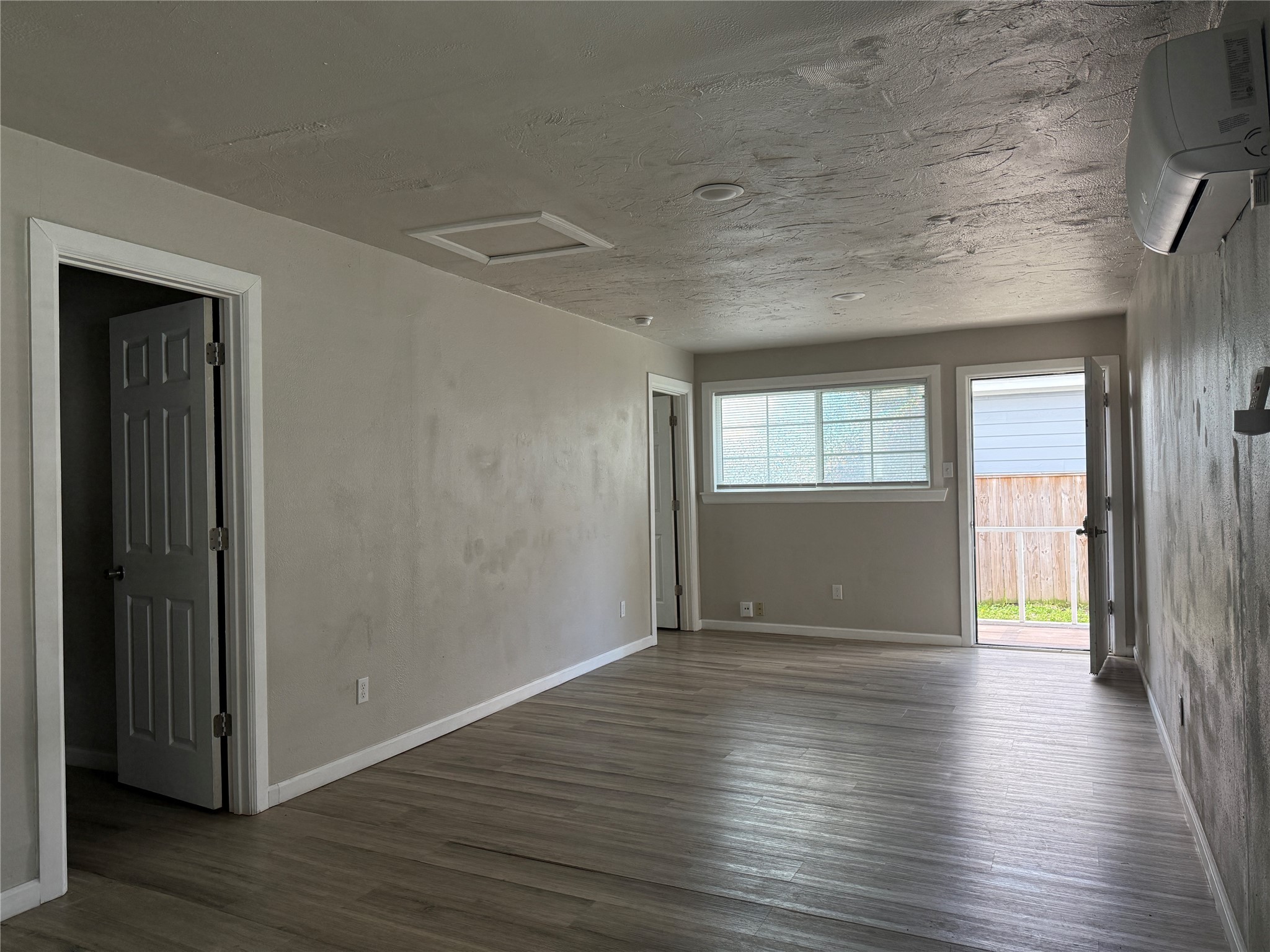 8510 Safeguard Street, Unit 3 Houston, TX 77051 - Photo 5 of 11 wooden floor in an empty room with a window