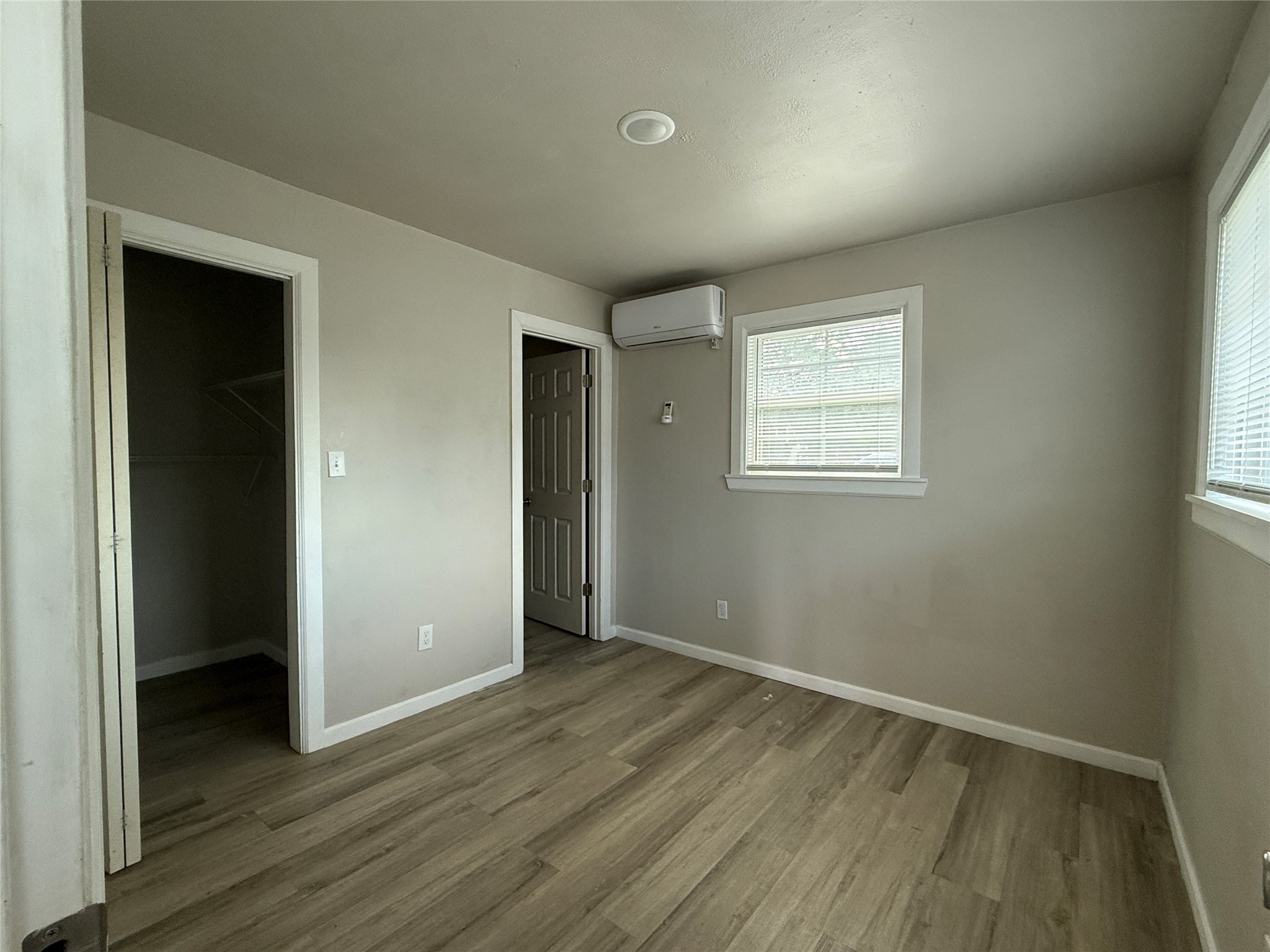 8510 Safeguard Street, Unit 3 Houston, TX 77051 - Photo 6 of 11 an empty room with wooden floor and windows