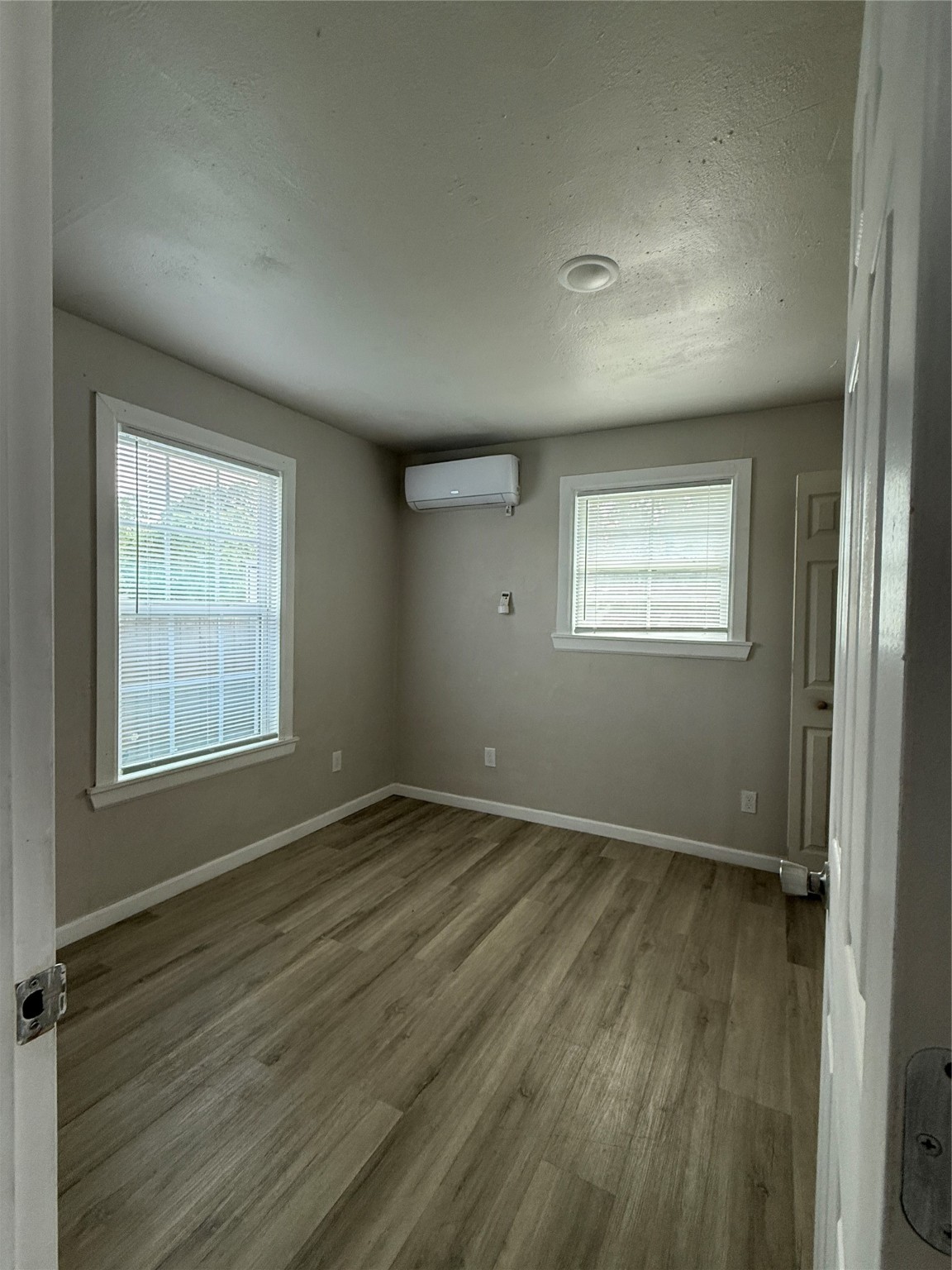 8510 Safeguard Street, Unit 3 Houston, TX 77051 - Photo 9 of 11 an empty room with wooden floor and windows