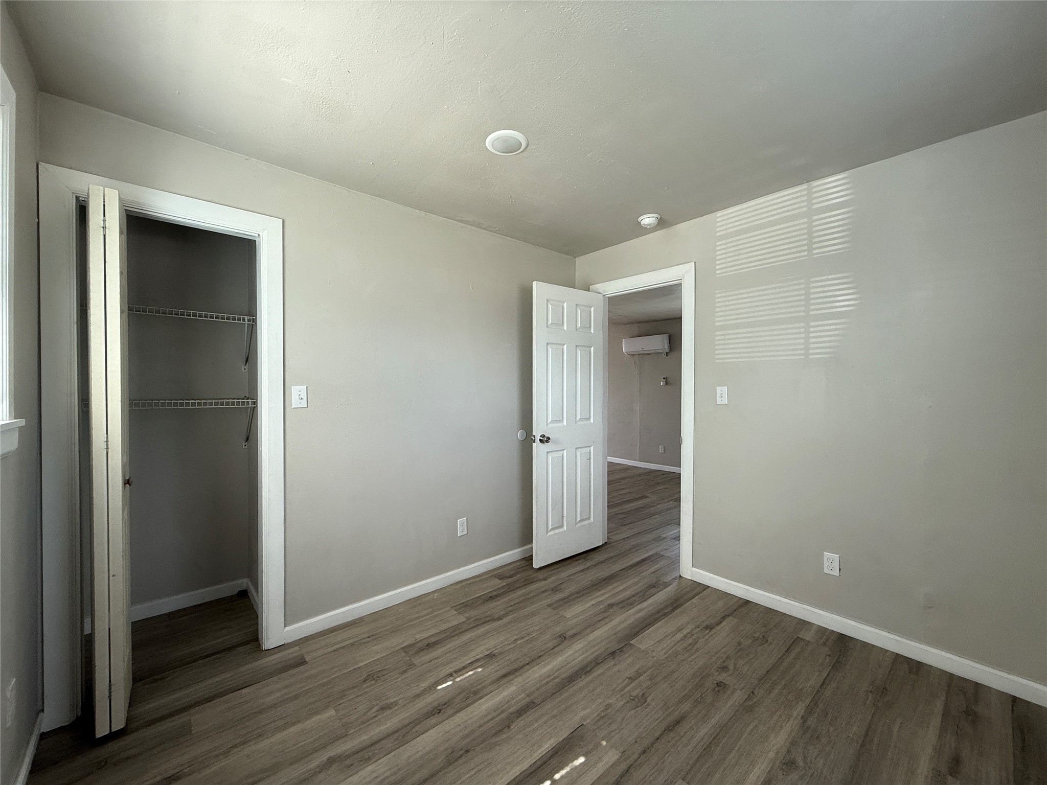 8510 Safeguard Street, Unit 3 Houston, TX 77051 - Photo 10 of 11 a view of an empty room with wooden floor and closet
