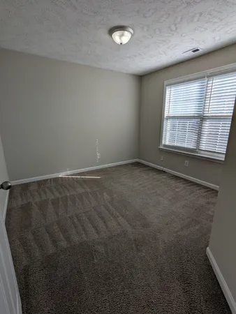 an empty room with a empty space and windows
