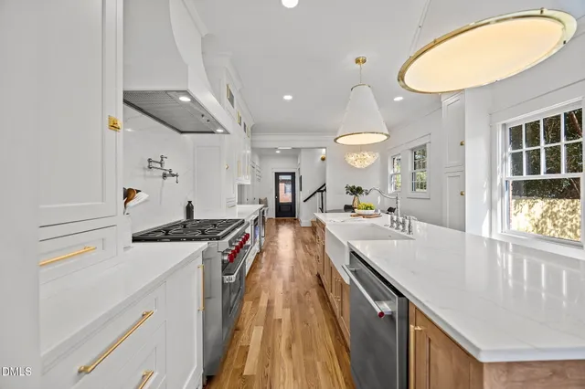 a large kitchen with stainless steel appliances granite countertop a lot of counter space and a sink