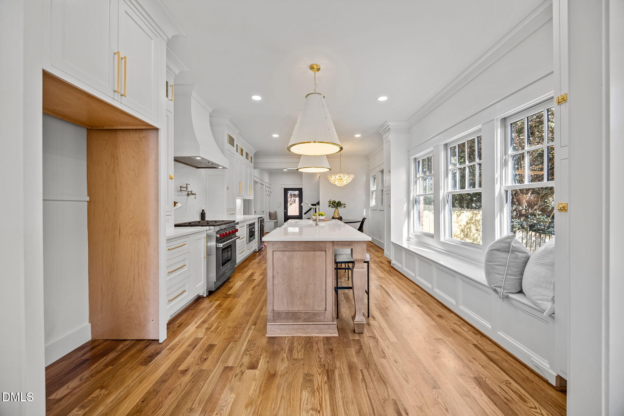1710 Fairview Road Raleigh, NC 27608 - Photo 11 of 44 a large white kitchen with wooden floor and a window