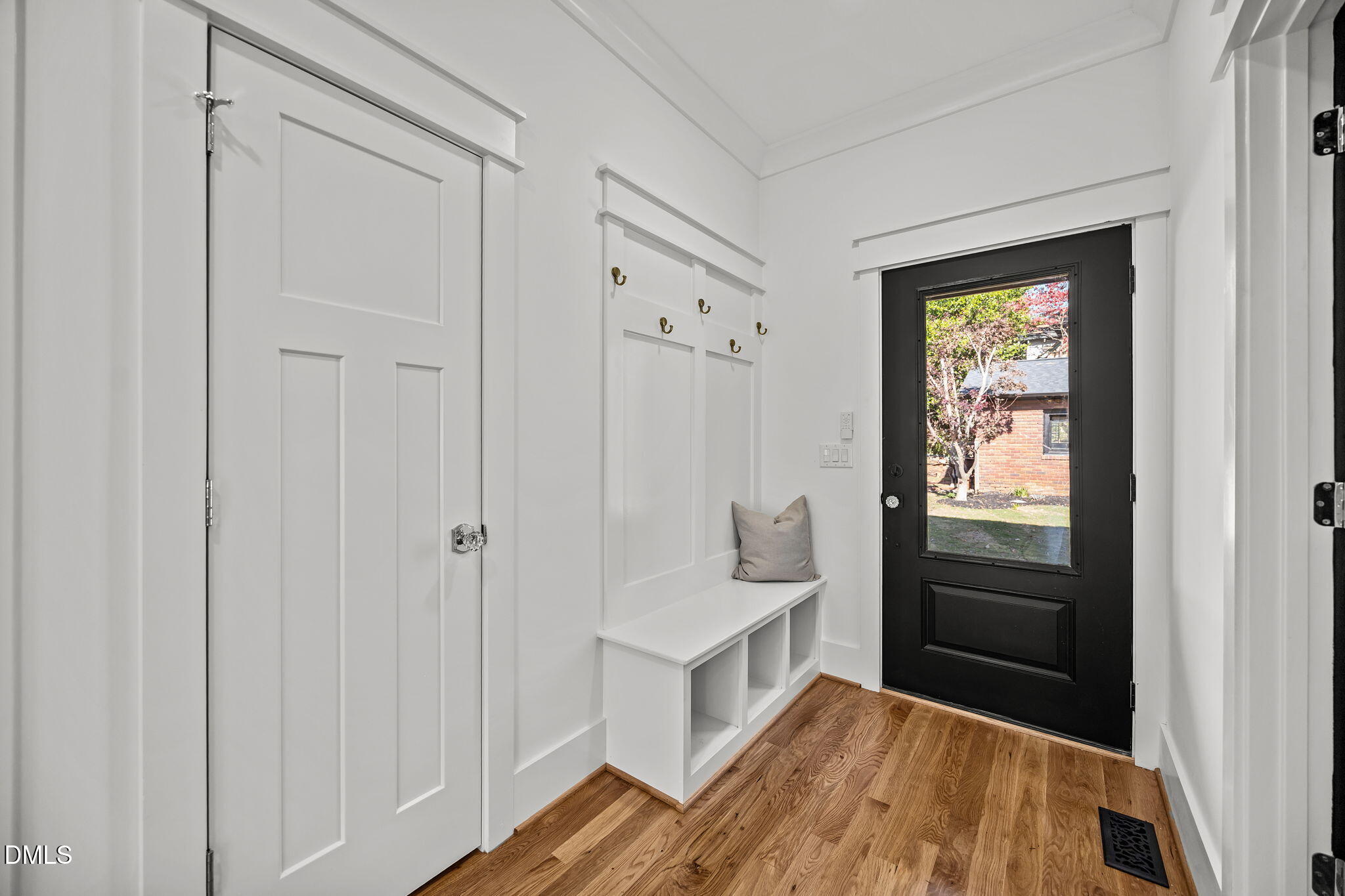 1710 Fairview Road Raleigh, NC 27608 - Photo 13 of 44 a hallway with white doors wooden floor and front door