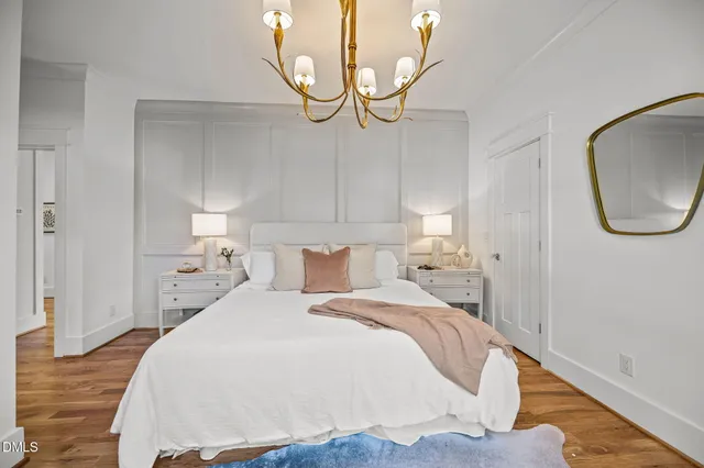 a bedroom with a bed and a mirror