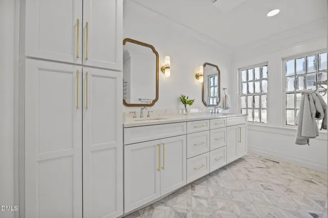 a bathroom with a double vanity sink and mirror