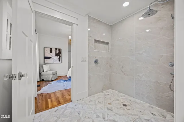 a bathroom with a tub shower and sink