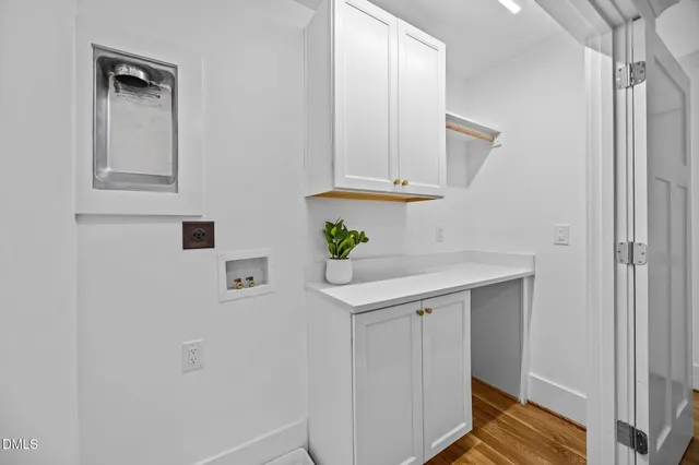 a view of kitchen with cabinets and wooden floor