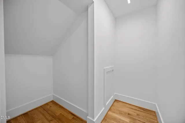 a view of a room with wooden floor and small space