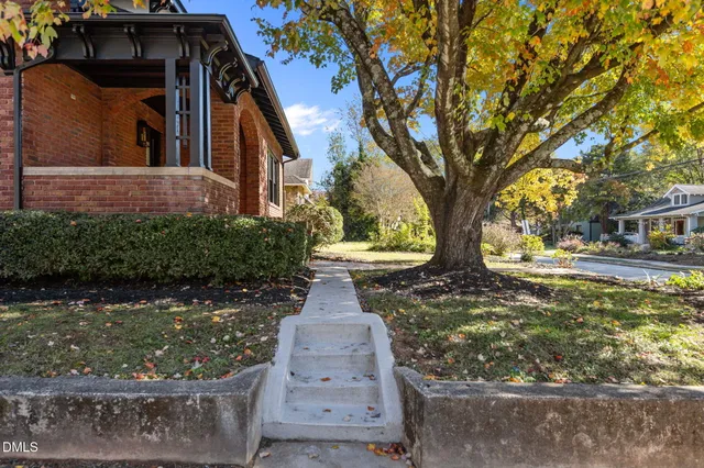 a front view of a house with a yard and fountain