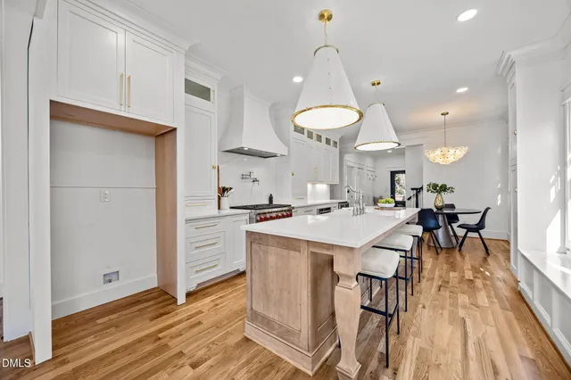 a kitchen with a table chairs refrigerator and cabinets