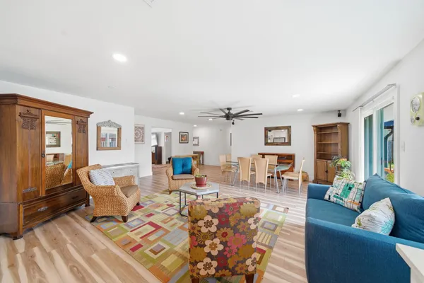 a living room with furniture and wooden floor