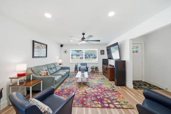 a living room with furniture and a wooden floor