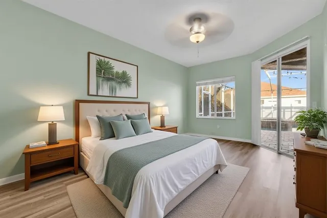 a spacious bathroom with a granite countertop sink a large mirror and a bathtub