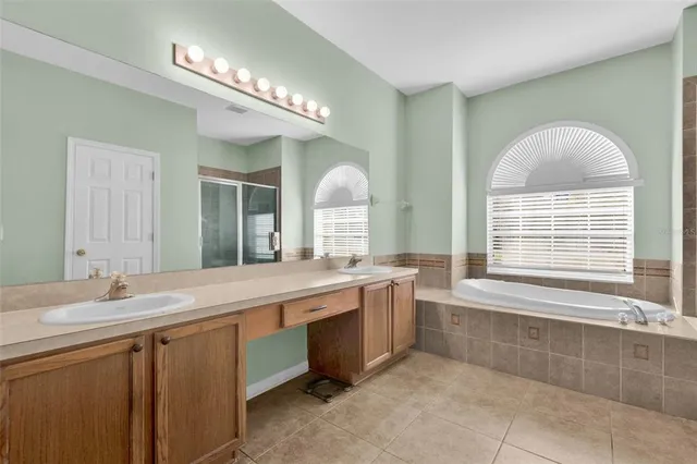 a bathroom with a tub and a shower