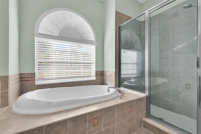 a dining room with wooden floor a chandelier a wooden table and chairs