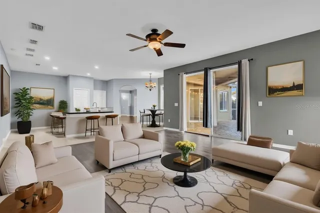 a kitchen with stainless steel appliances granite countertop a stove and white cabinets