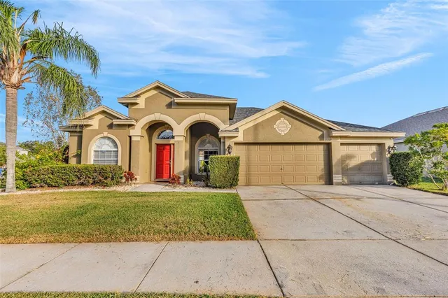 a front view of a house with a yard and garage