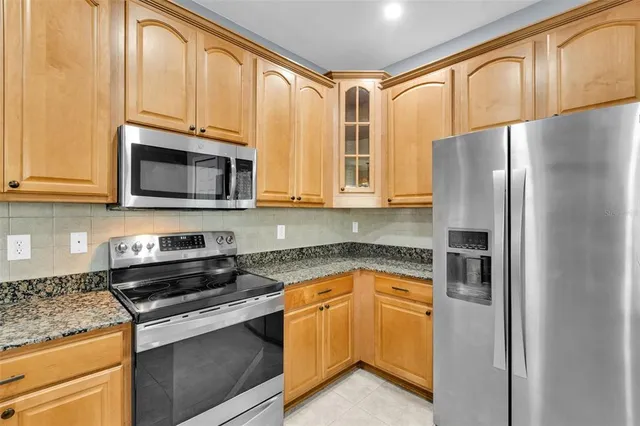a bathroom with a granite countertop sink a large mirror and a bathtub