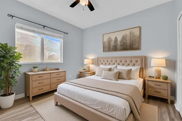 a bedroom with a large bed and a flat tv screen on dresser