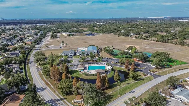 a view of a swimming pool with a table and chairs under an umbrella