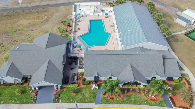 an aerial view of a house with a yard