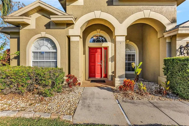 a living room with furniture a flat screen tv and a large window