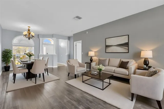a living room with furniture and a potted plant