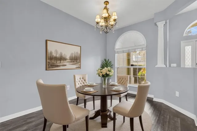 a bedroom with bed and a flat tv screen on dresser