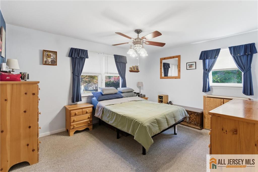 286 William Street Piscataway, NJ 08854 - Photo 11 of 23 a spacious bedroom with a bed and a chandelier