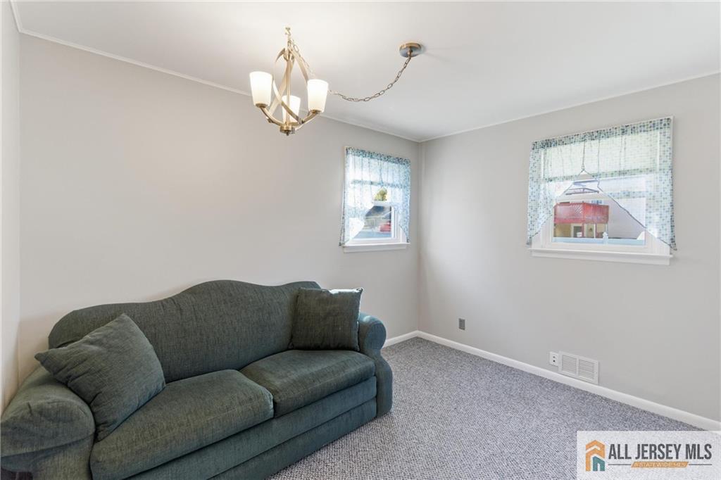286 William Street Piscataway, NJ 08854 - Photo 15 of 23 a living room with furniture a chandelier and a window