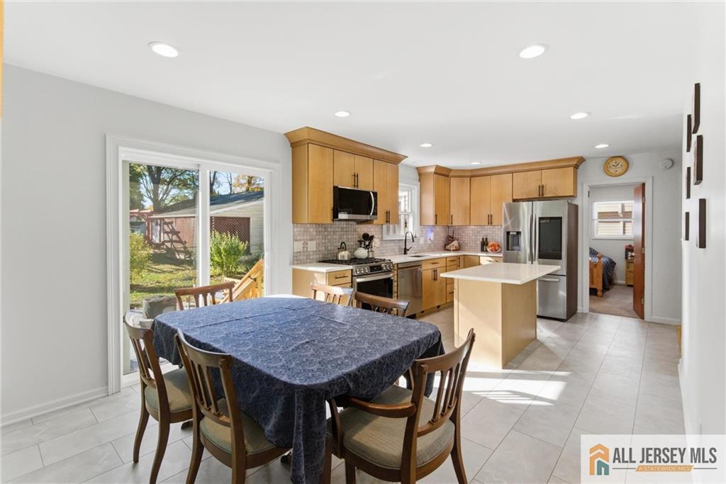 286 William Street Piscataway, NJ 08854 - Photo 8 of 23 a view of a dining room with furniture wooden floor and a kitchen