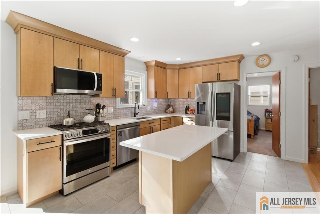 286 William Street Piscataway, NJ 08854 - Photo 9 of 23 a kitchen with a sink a stove and refrigerator
