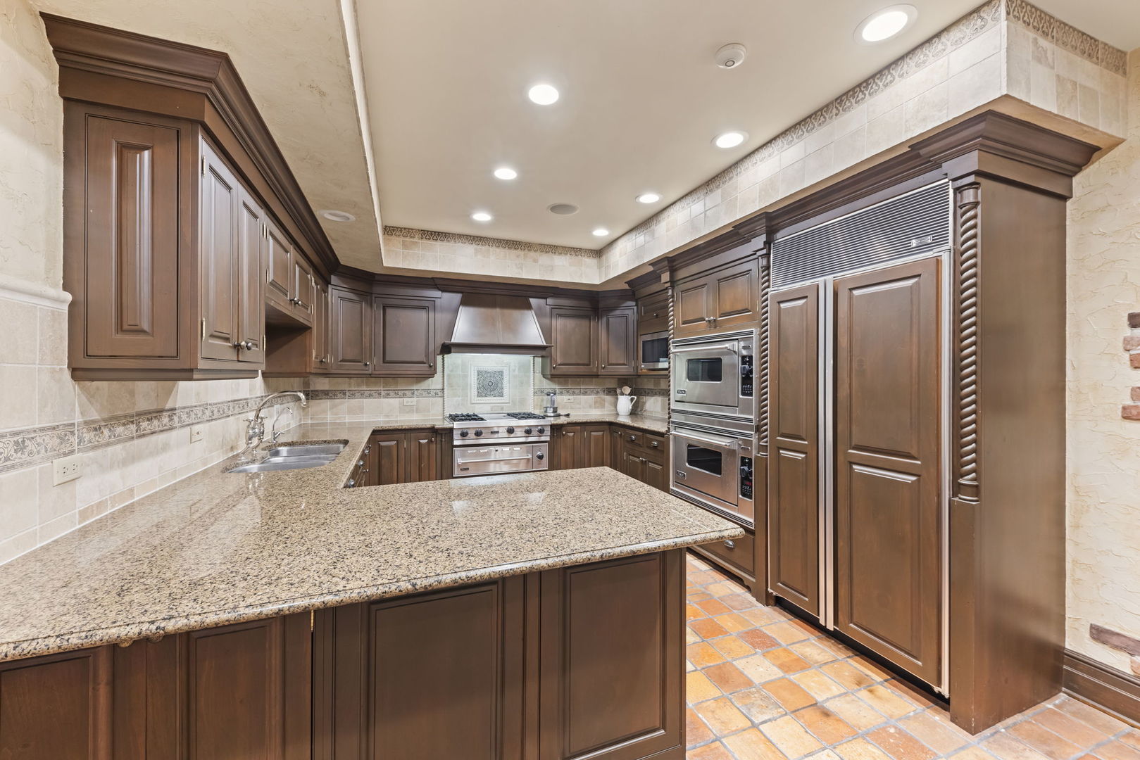 24W141 Hobson Road Naperville, IL 60540 - Photo 25 of 70 a kitchen with stainless steel appliances granite countertop a refrigerator a sink and wooden cabinets