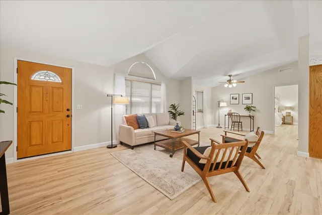 a living room with furniture and wooden floor