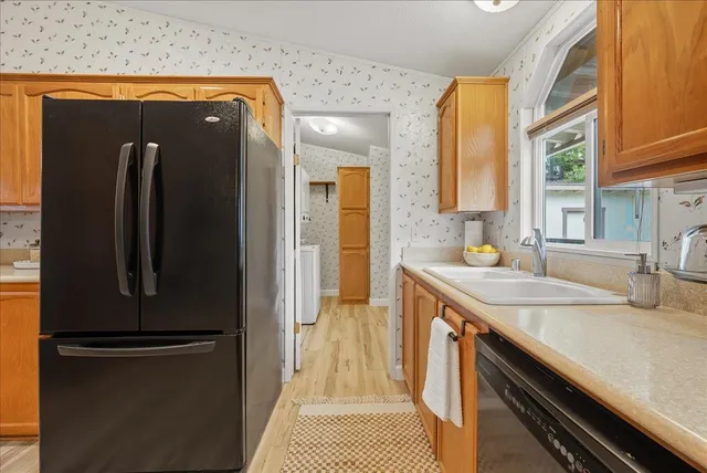 a kitchen with stainless steel appliances a refrigerator and a stove