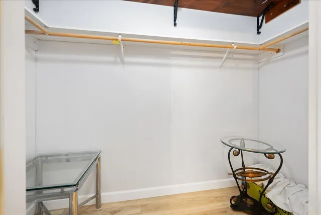 a view of a room with wooden floor table and closet