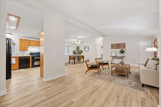 a dining room with wooden floor and a chandelier