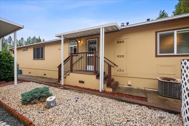 a view of a porch with wooden floor and iron stairs