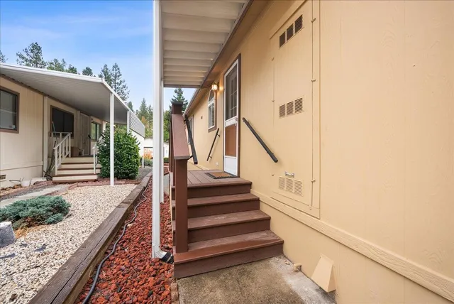 a view of a house with a garage and potted plants